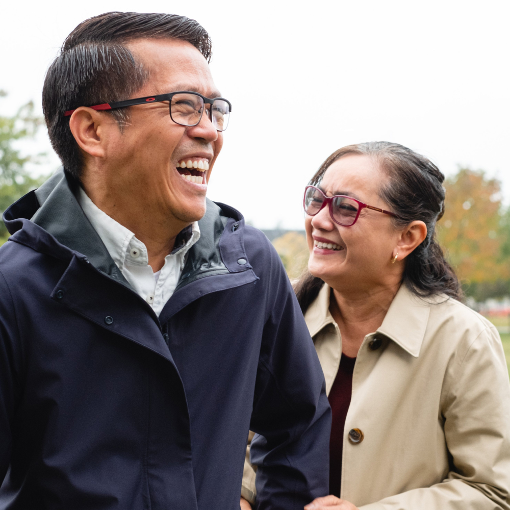 couple-laugh-in-a-local-park